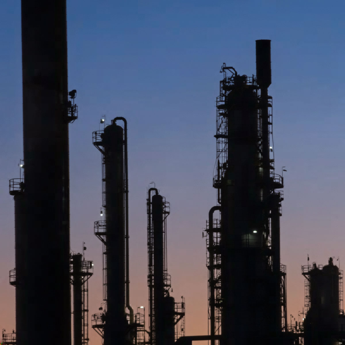 Firefly_-This-image-shows-the-silhouette-of-an-industrial-refinery-or-processing-plant-with-t-757851